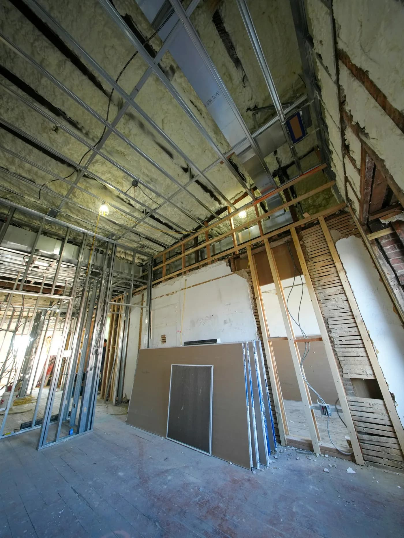 Metal framing and gypsum board sheets on a working site